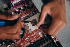 a student repairing a motherboard