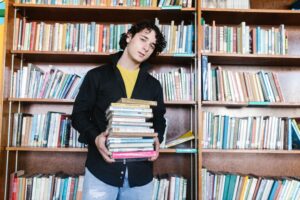 University student with books in the library