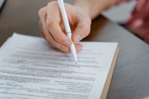 student signing an admission document