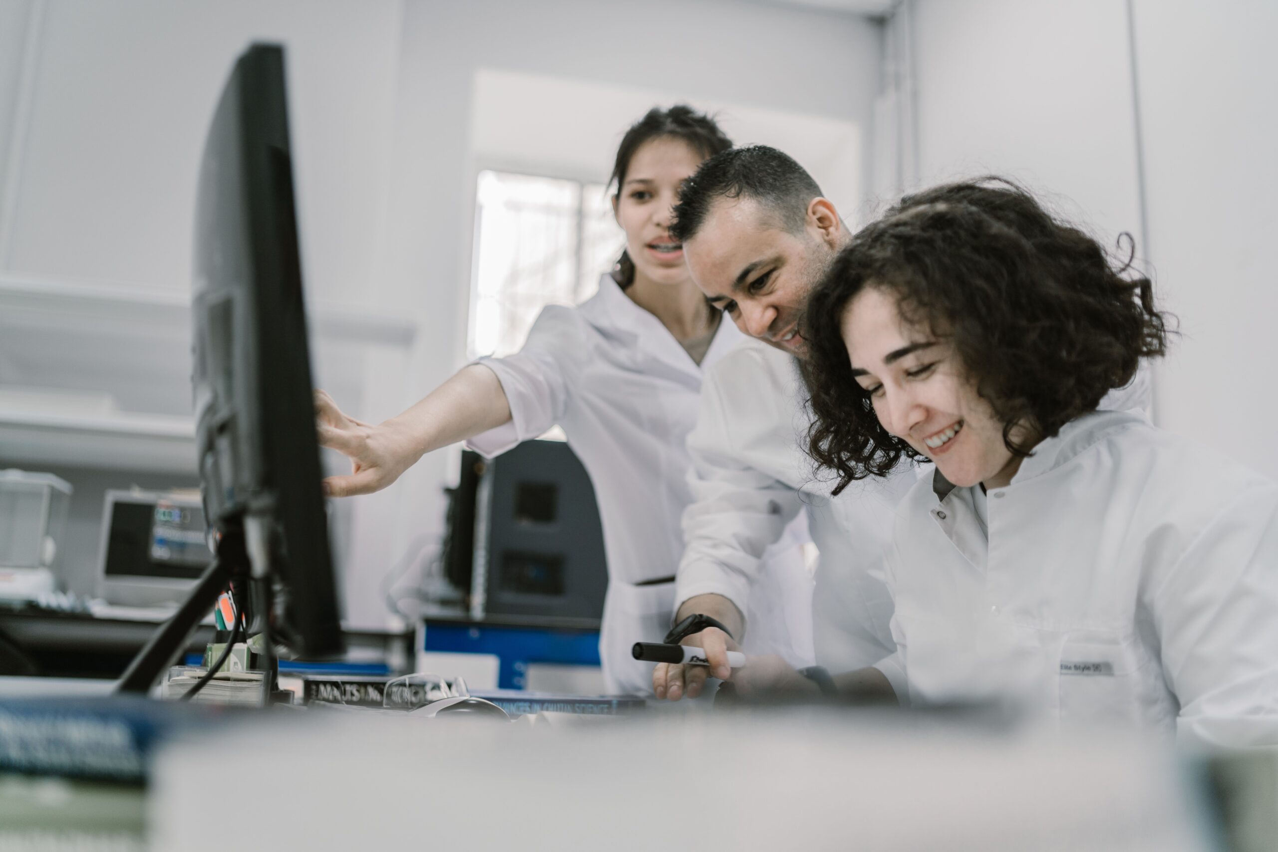 Group of diverse scientists working together on a computer